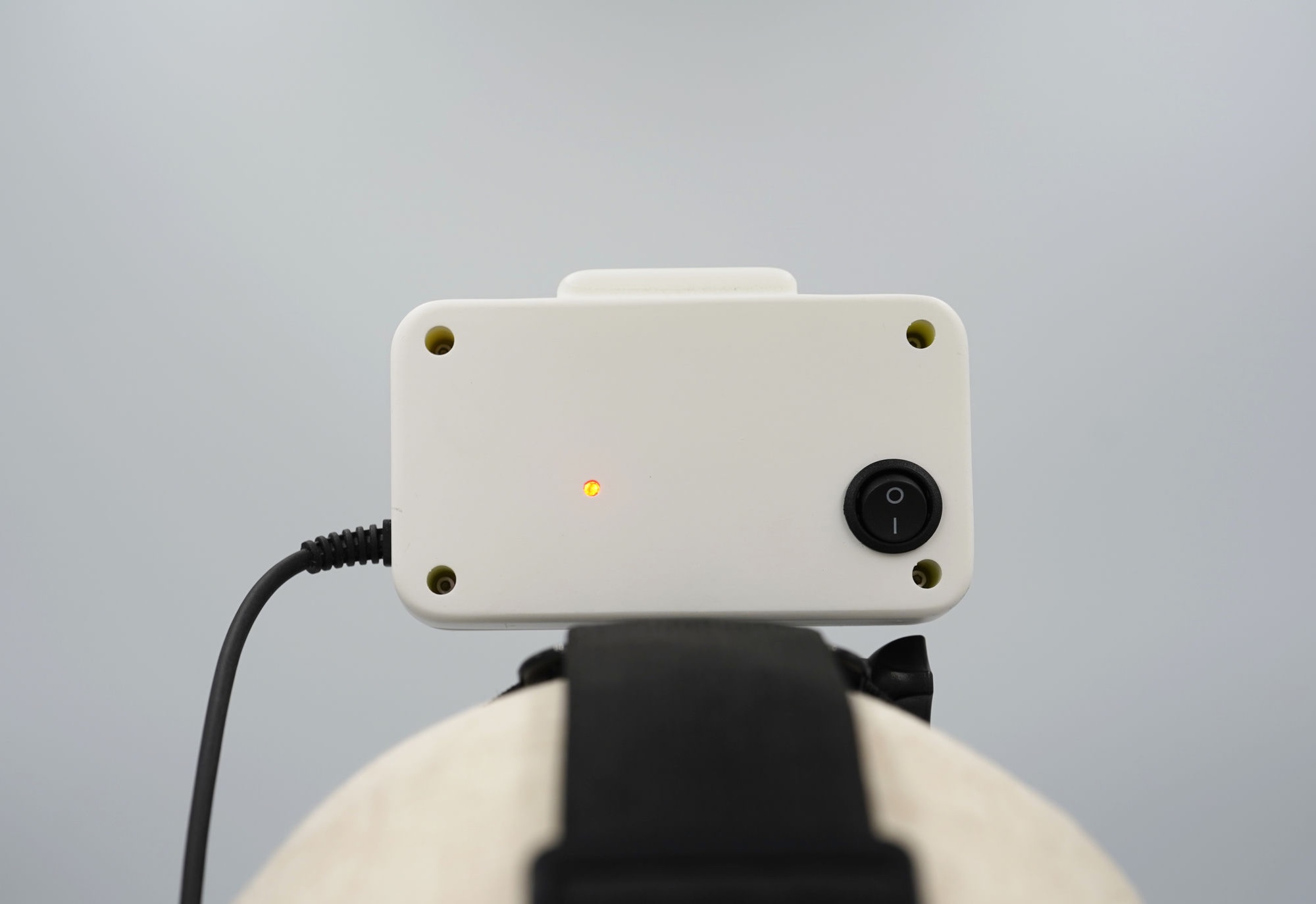 GI Ego1 rear view showing the power switch, status LED, and headband mount